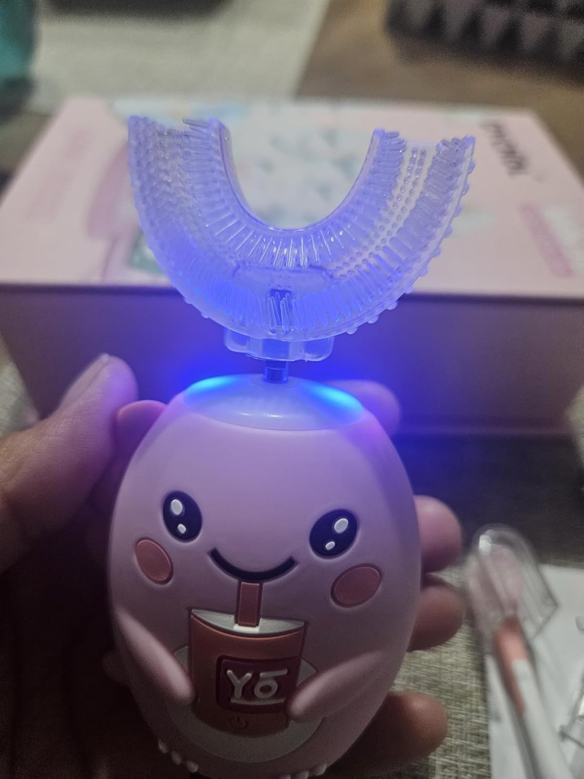 SnugBrush head lit by the blue sanitizing light